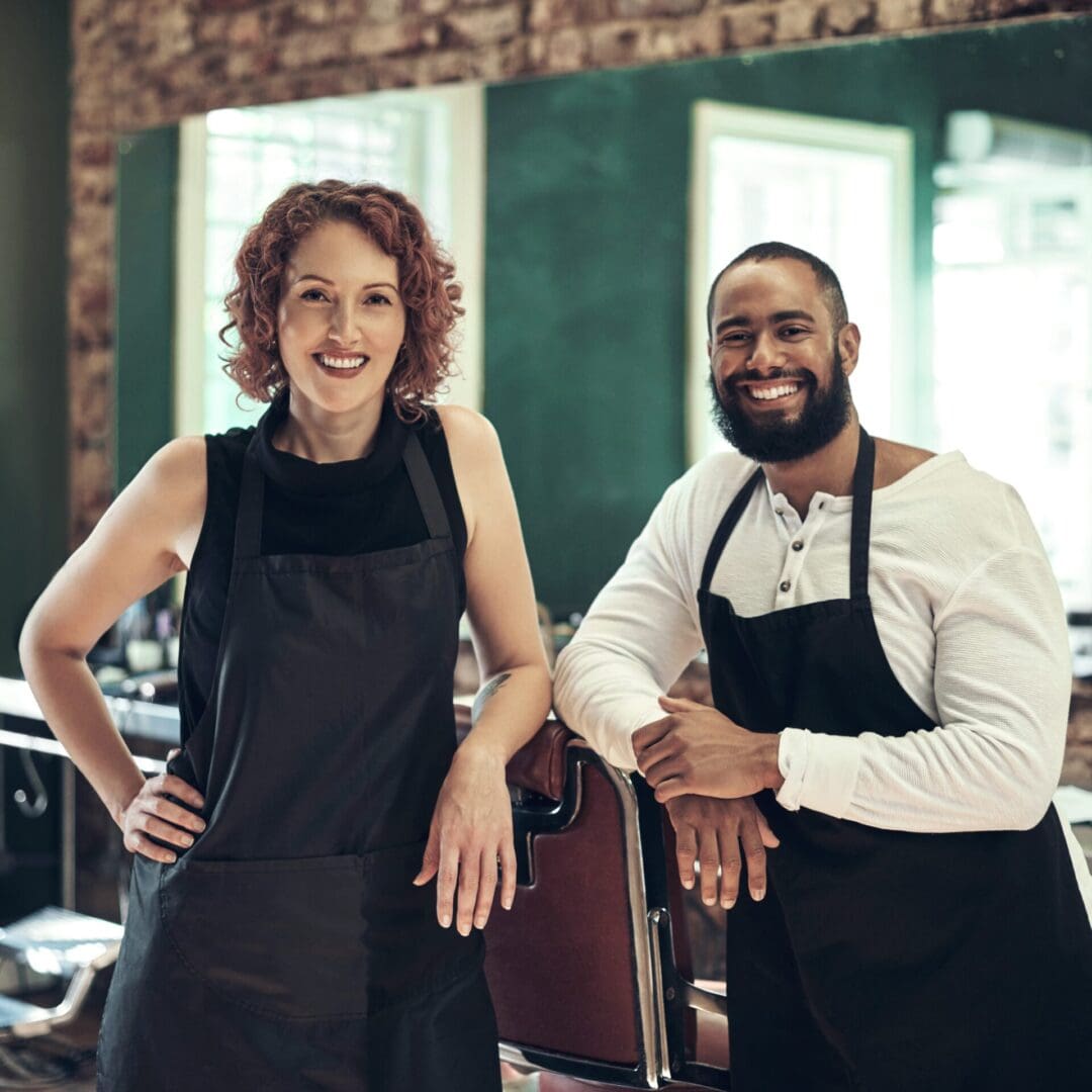 Two people standing next to each other in a restaurant.